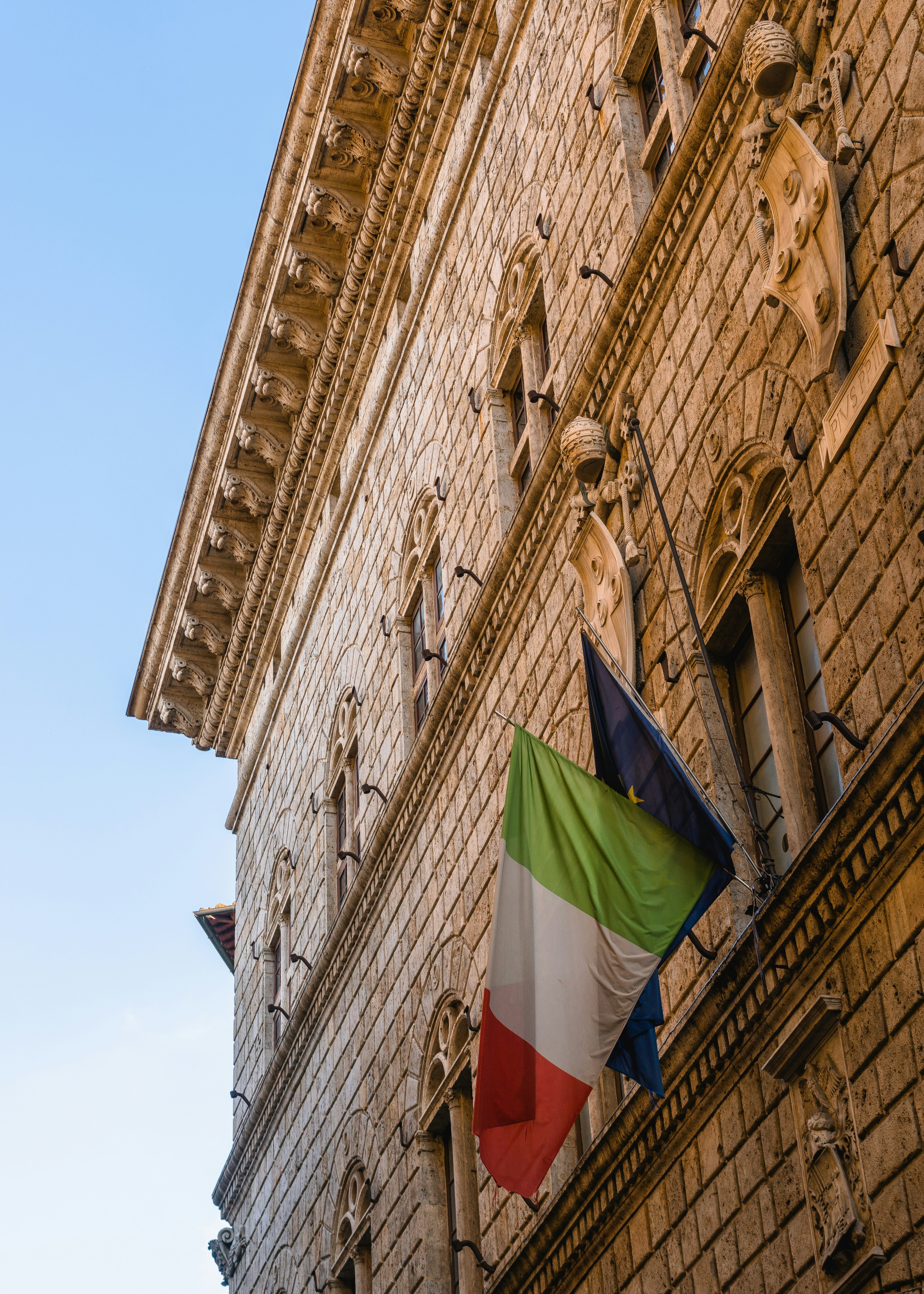 green red and yellow flag on brown concrete building